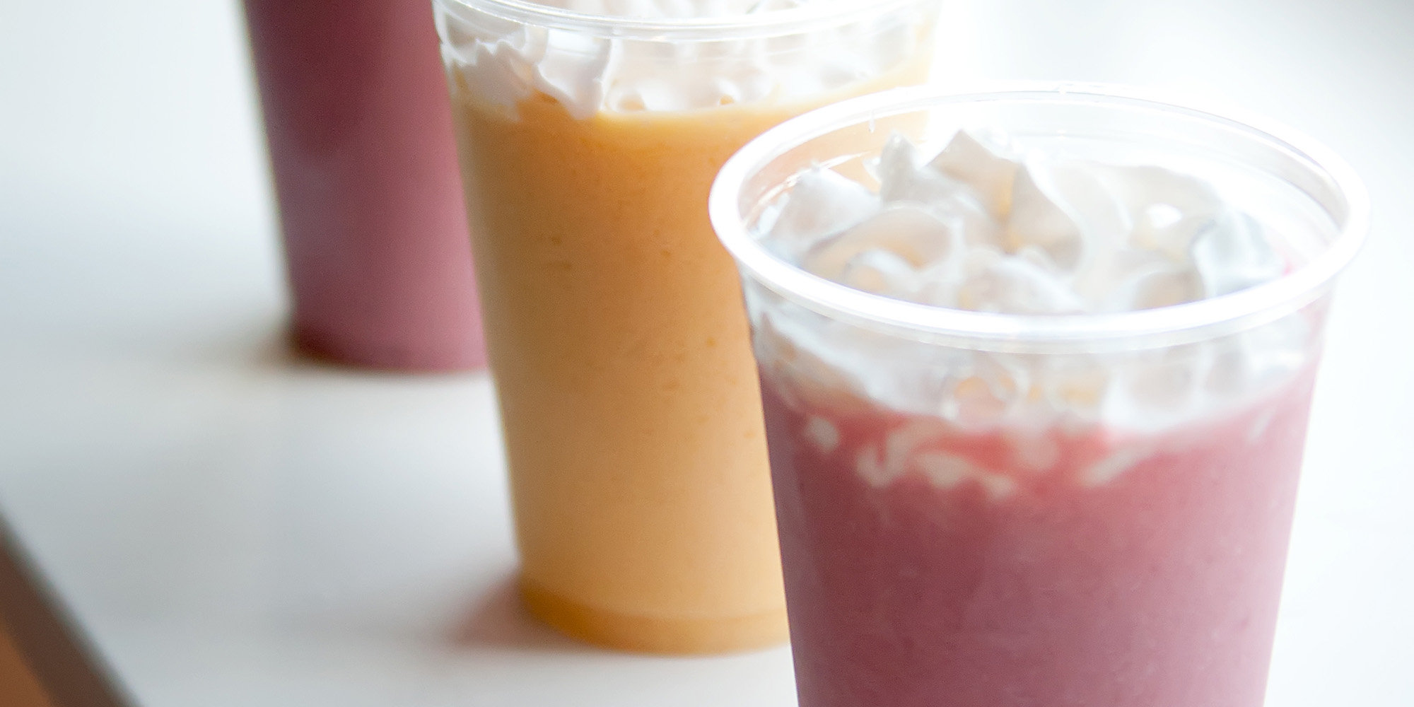 three smoothies in clear cups from a Pacific Perks event
