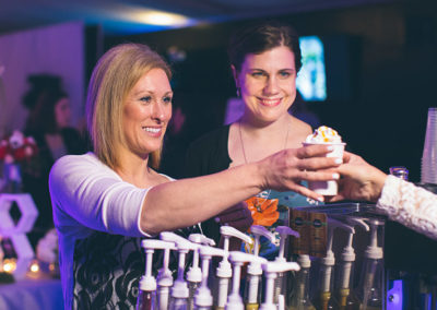 A woman receives a drink at a Pacific Perks espresso mobile café at a bar mitzvah