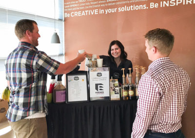a Pacific Perks Perkologist handing a guest a coffee drink during an Emerick event