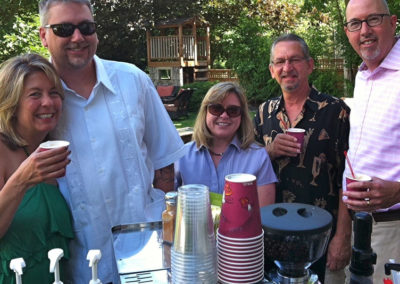 a group enjoy their drinks at an outdoor Pacific Perks mobile espresso café