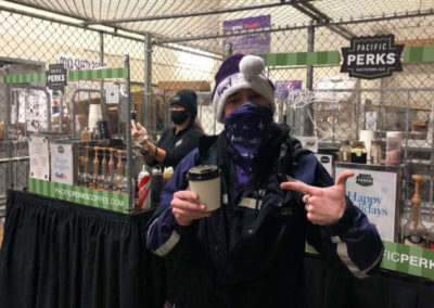 a Fed Ex teammate posing with their Pacific Perks espresso drink