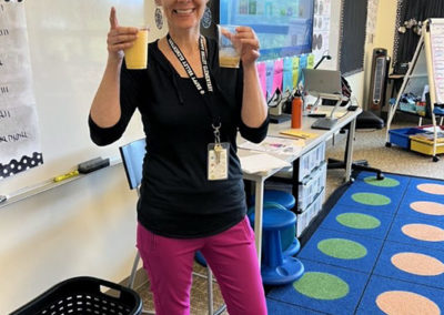 a Happy Valley teacher smiling with their Pacific Perks smoothie during an appreciation event