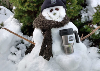 a snowman with Pacific Perks beanie and thermos