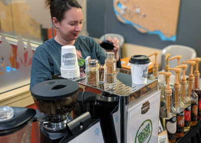 a Perkologist preparing a coffee drink during a SHARE event