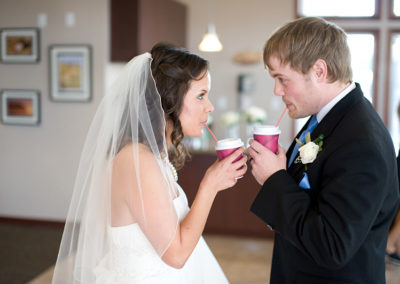A newlywed couple sip their Pacific Perks espresso drinks at their wedding