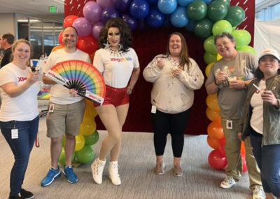 a group poses at an XPO Logistics Pride event hosted with a Pacific Perks espresso mobile café