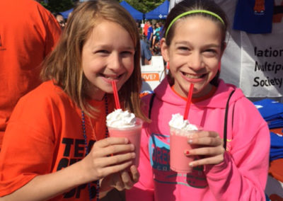 Morgan and Sarah enjoy Pacific Perks smoothies at an outdoor event