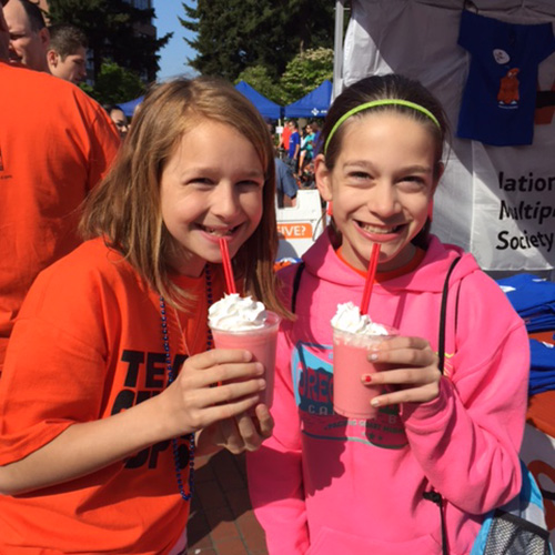 Morgan and Sarah enjoy Pacific Perks smoothies at an outdoor event