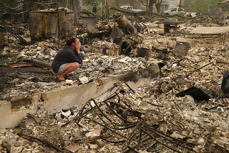 a person looks over the aftermath of an Oregon wildfire
