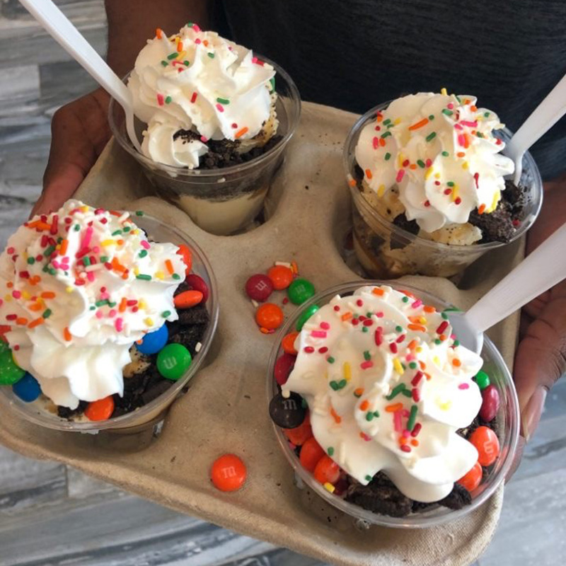 four ice cream sundaes on a tray from a Pacific Perks mobile café