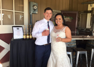 a couple on their wedding day holding drinks from a Pacific Perks Coffee mobile café