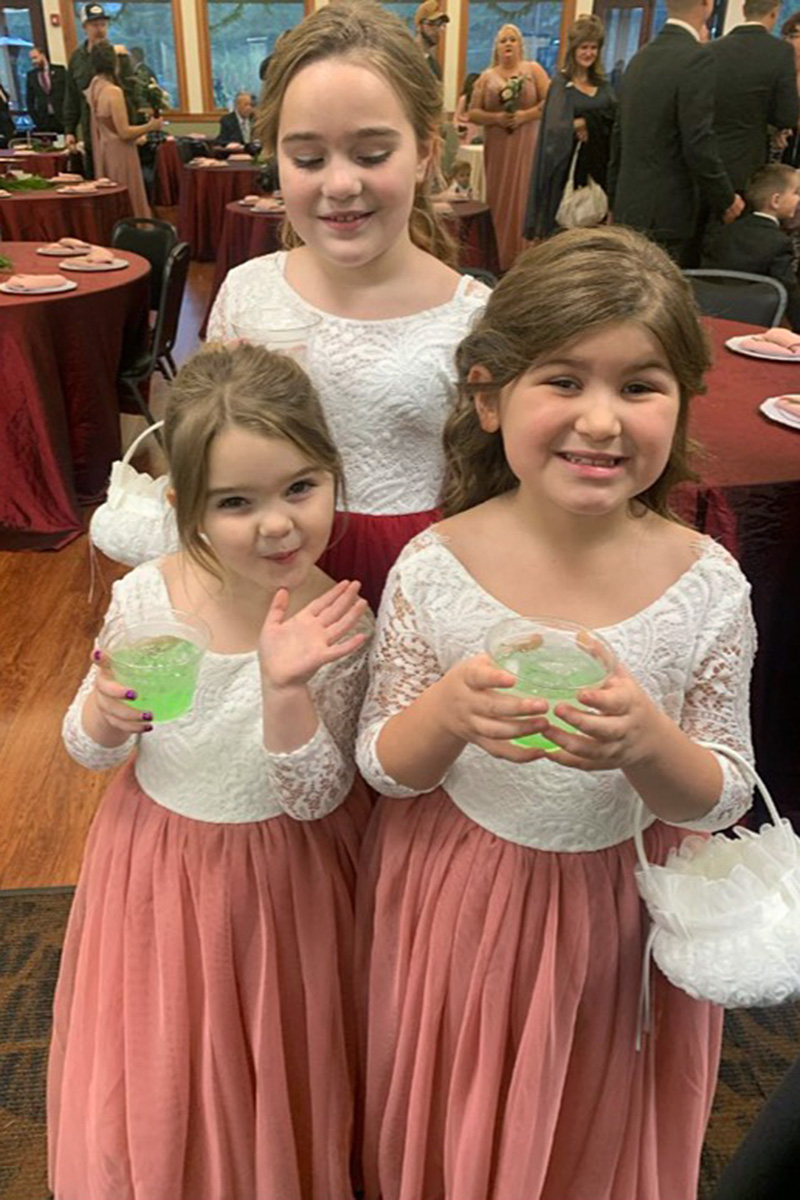 three flower girls holding Italian sodas from a Pacific Perks Coffee espresso bar mobile café during a wedding reception