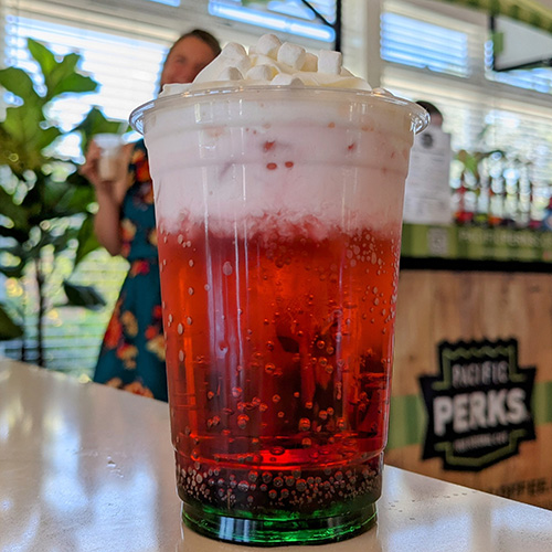 A red dirty soda from a Pacific Perks Coffee mobile café with marshmallows and whipped cream