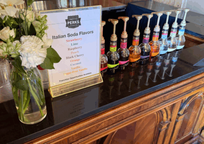 A Pacific Perks menu along with Pacific Perks syrups at a bar at a wedding venue
