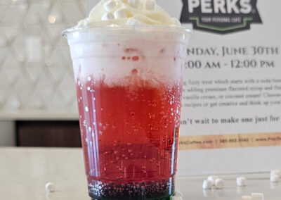 A red dirty soda from a Pacific Perks Coffee mobile café with marshmallows and whipped cream