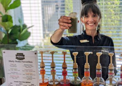 Kylie, a Pacific Perks Coffee Perkologist, serves a dirty soda from the mobile café