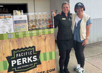 a Pacific Perks Perkologist smiling with a guest at an event with an espresso bar mobile café