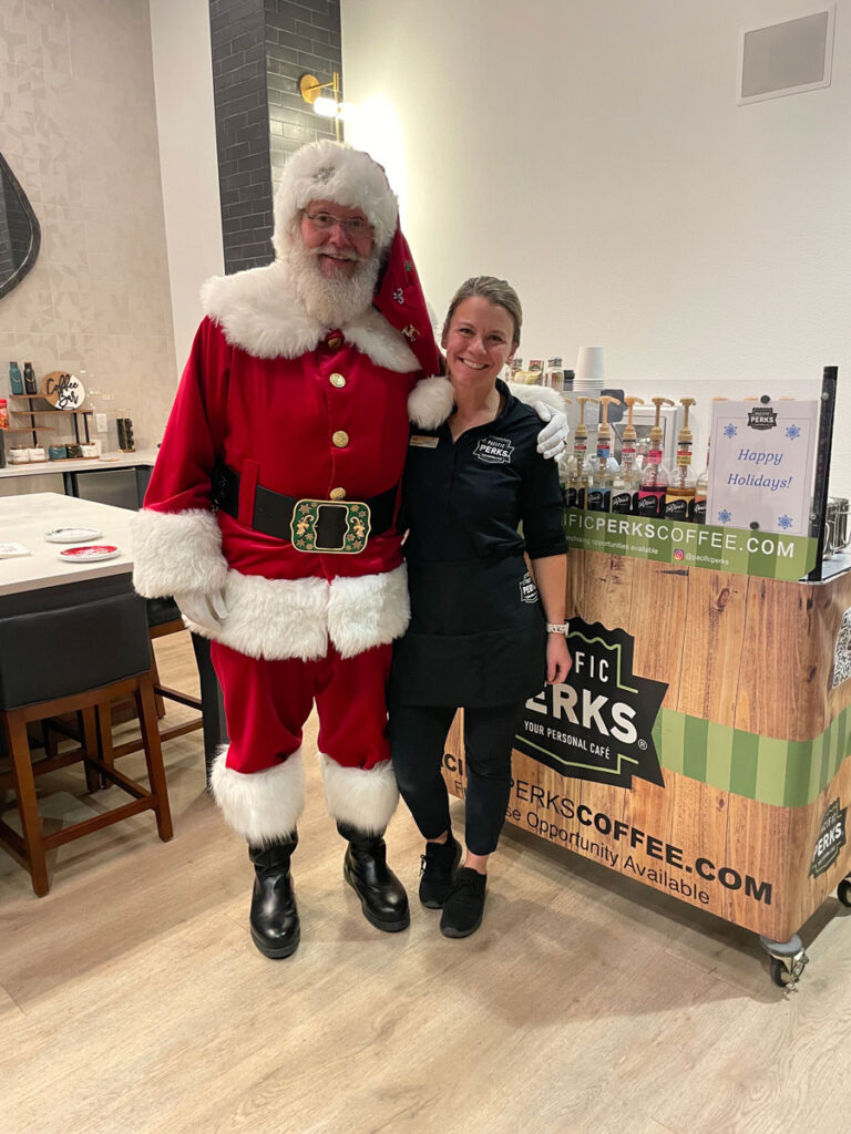 Kim, a Pacific Perks employee, with Santa Claus