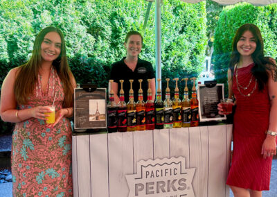 couple and Perkologist smiling at a Pacific Perks mobile Italian Soda bar at a wedding